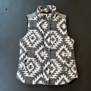 Skies are Blue puffy vest, black, grey, cream pattern.  Size small.